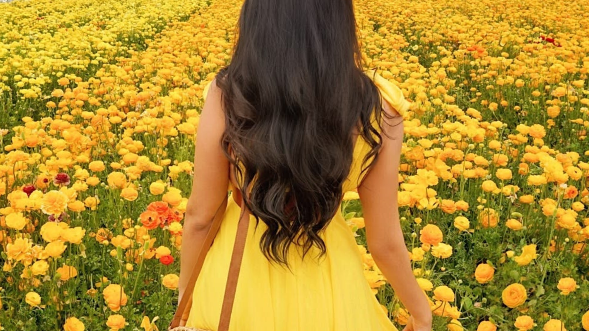 Woman in a yellow summer dress walking outside in golden June light - Glow Girl Wellness guide to things to do in the second half of June.