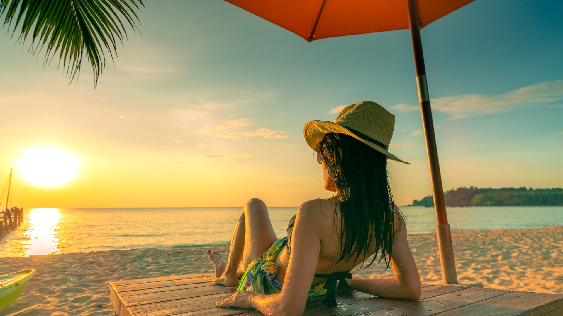 girl relaxing on beach at sunset