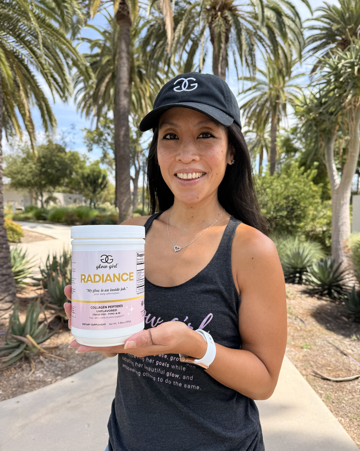 Stepha holding Radiance collagen under the palm trees in Southern California - THE GLOW UP chapter, About page