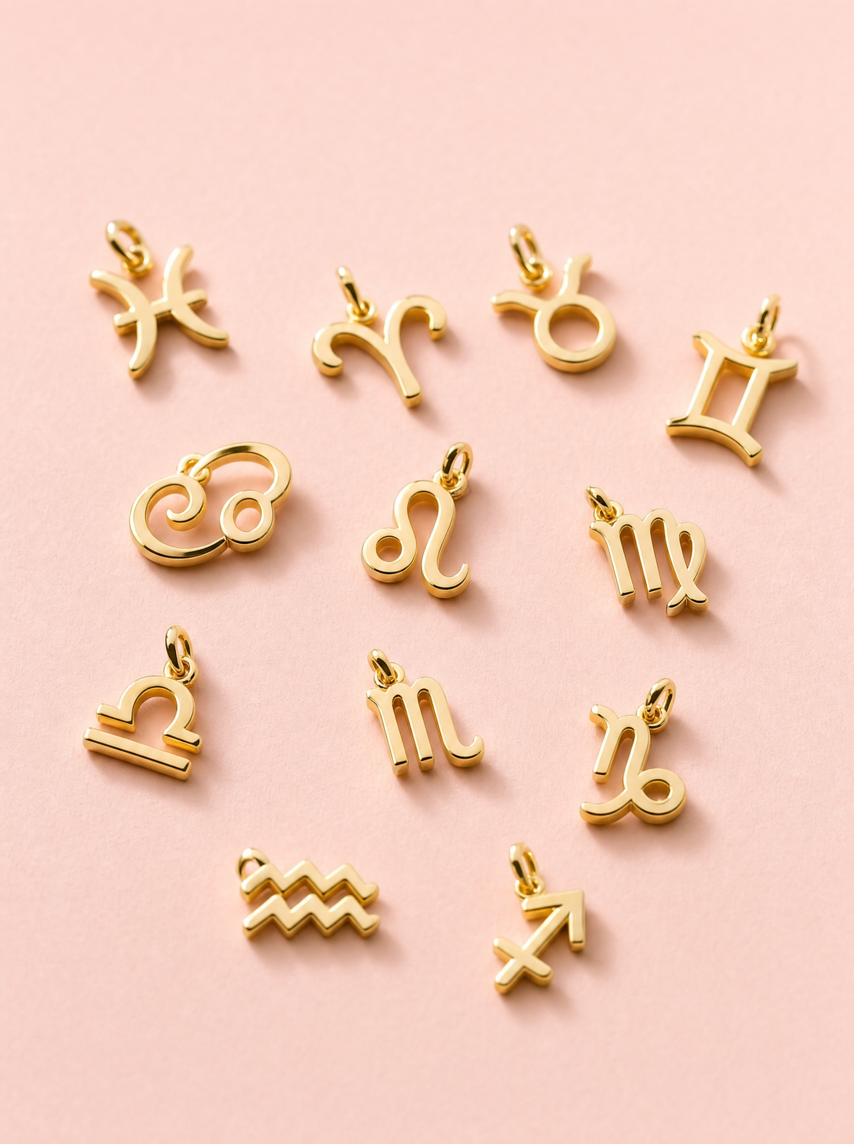 gold zodiac charms on blush - THE GLIMMER chapter, About page